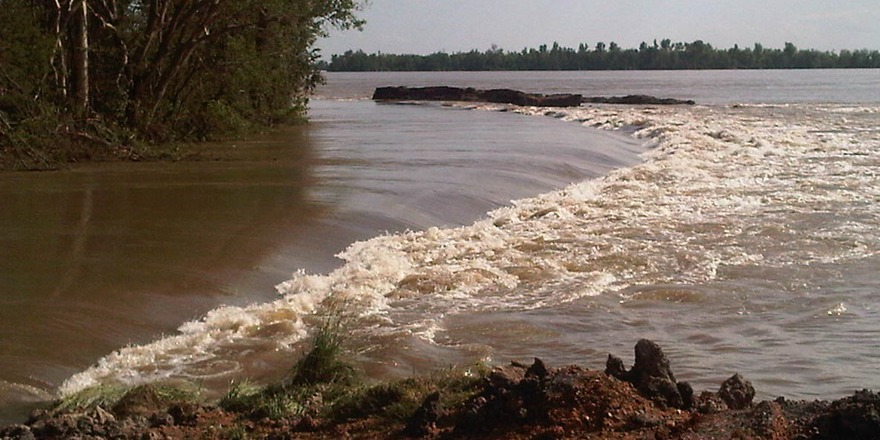 Water breaching levee along the Mississippi River