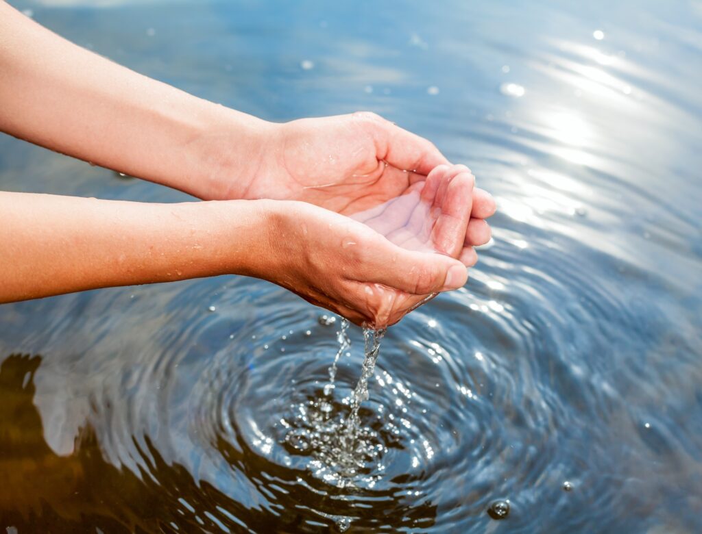 Holding water in cupped hands | Adobe